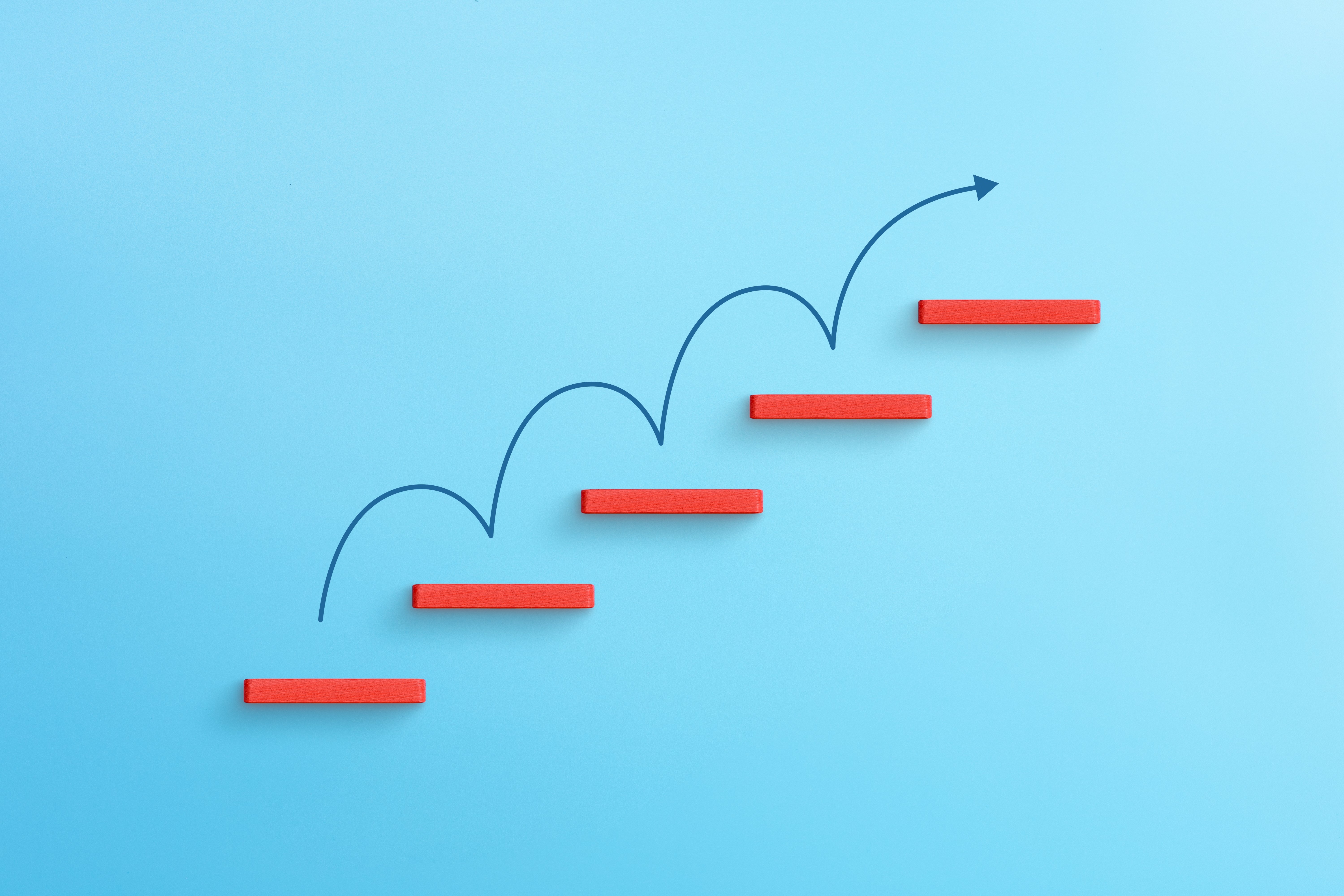 concept of growth illustrated by arrow going up stairs