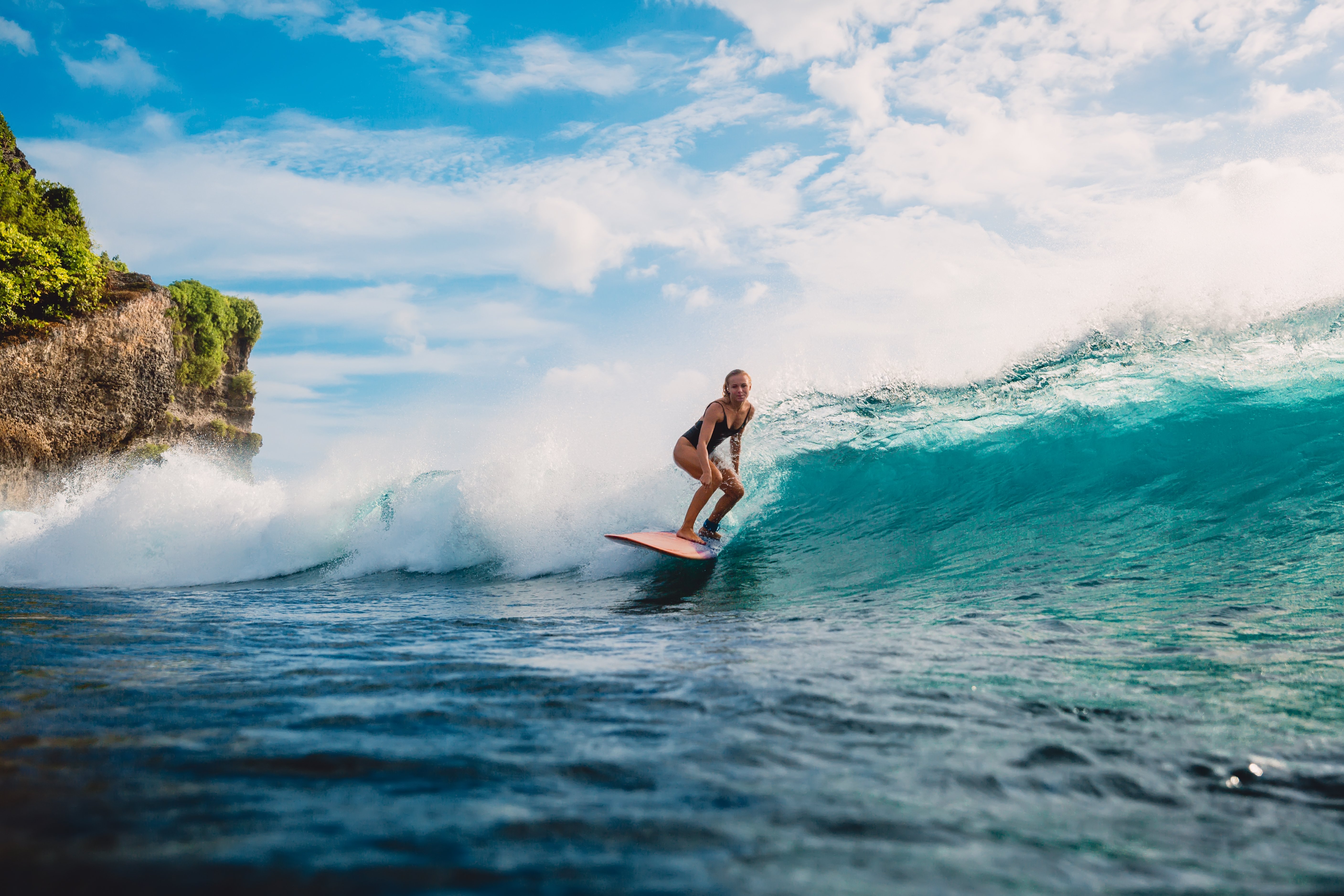 A woman surfs a wave