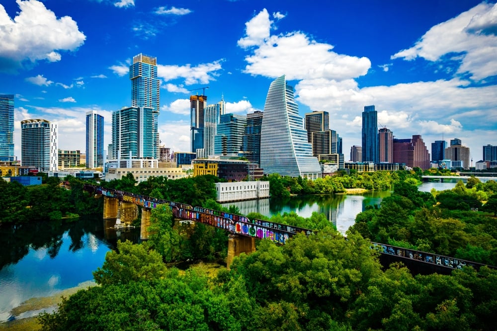 The Austin skyline surrounded by a river and forestry.