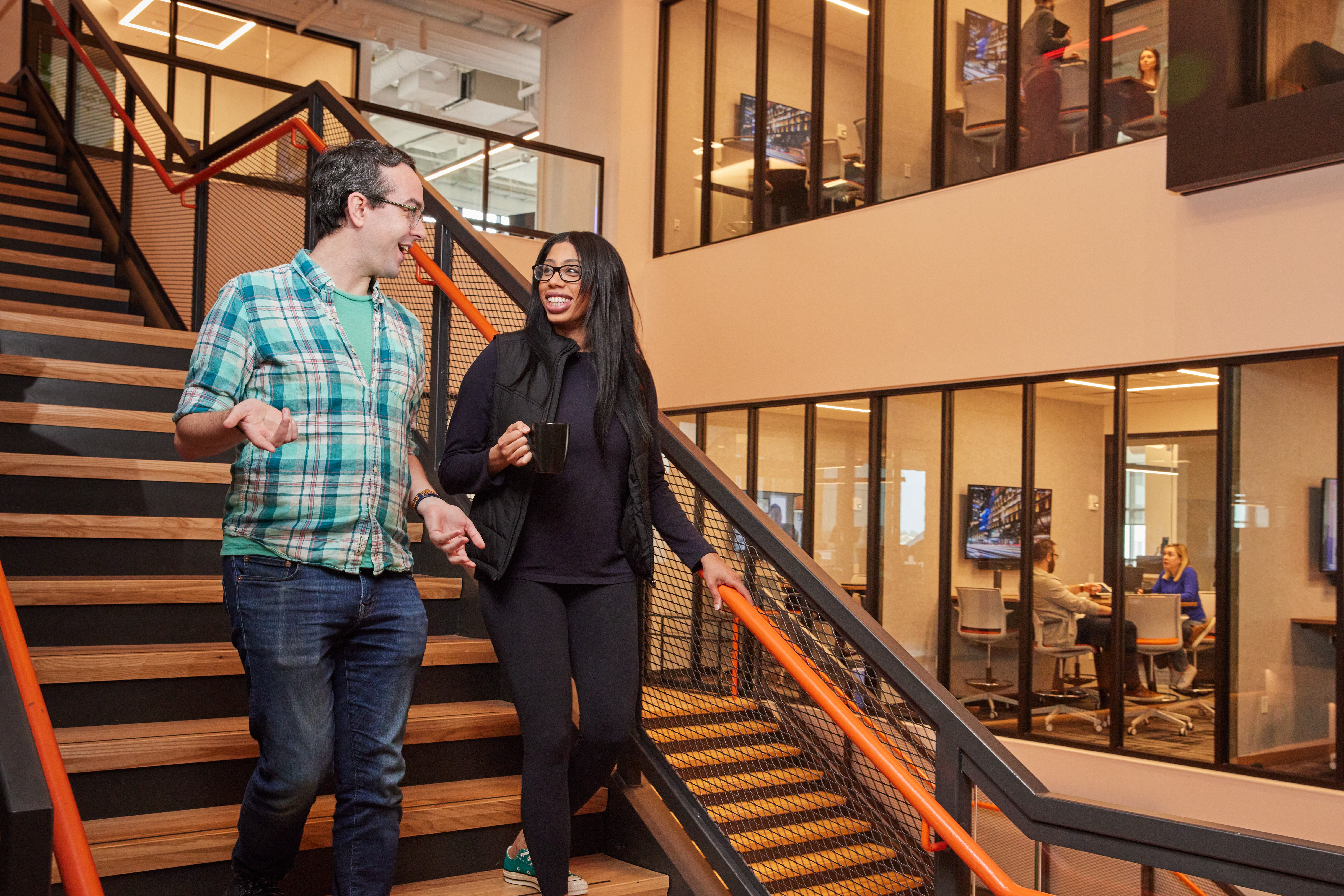 coworkers walking down stairs chatting