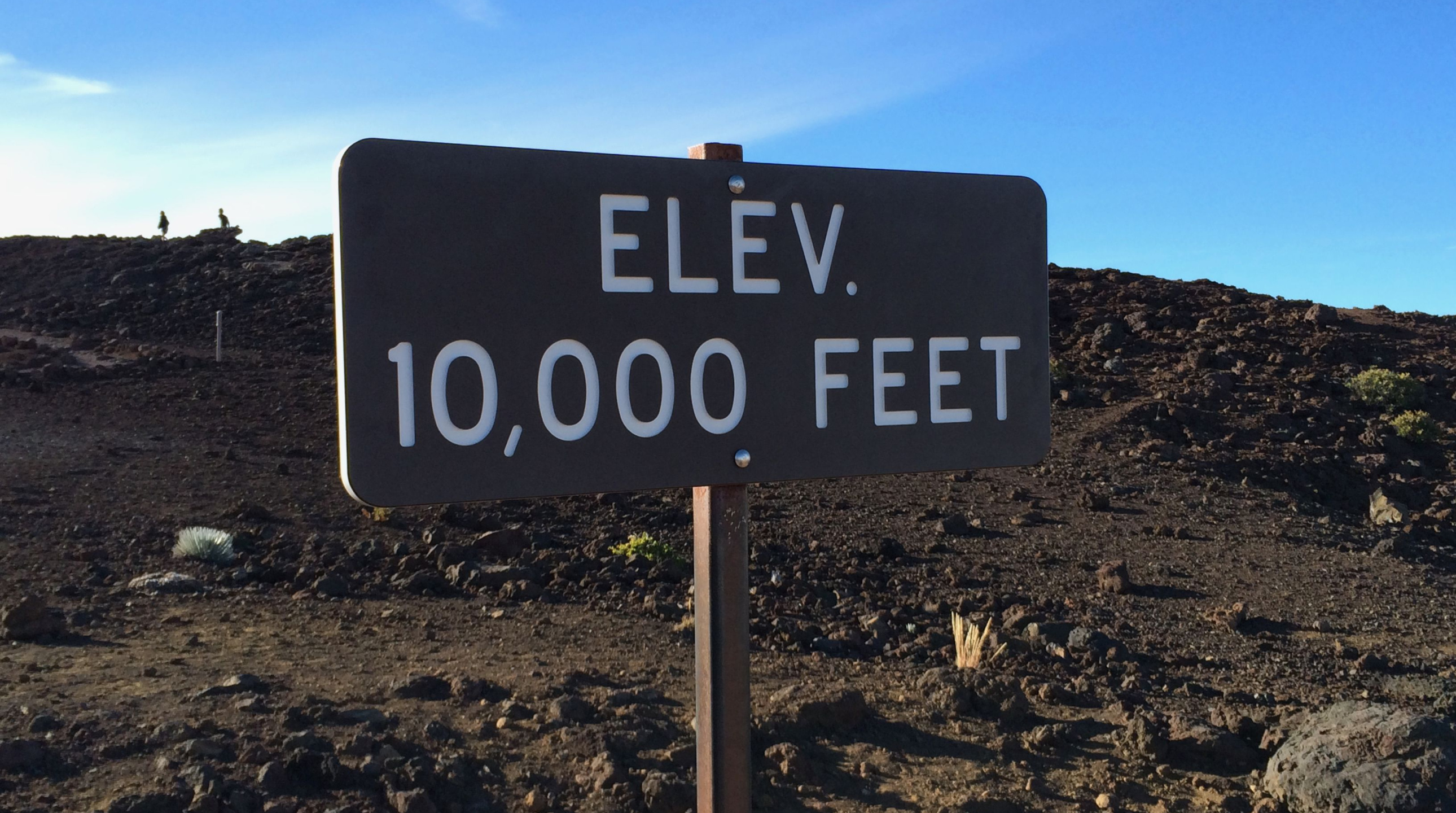 Photo of a sign that reads “Elev. 10,000 Feet”