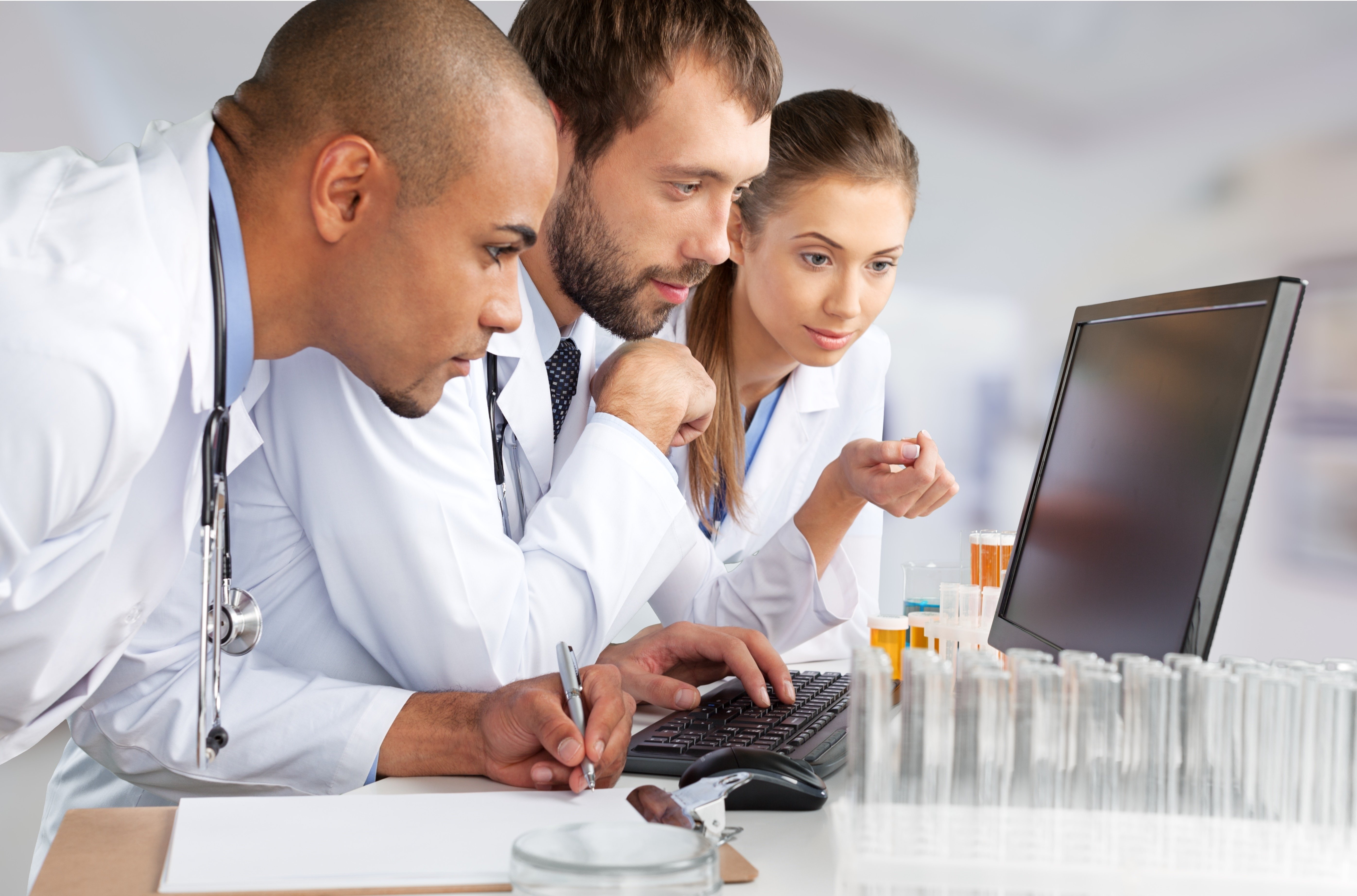 Healthcare team study computer monitor