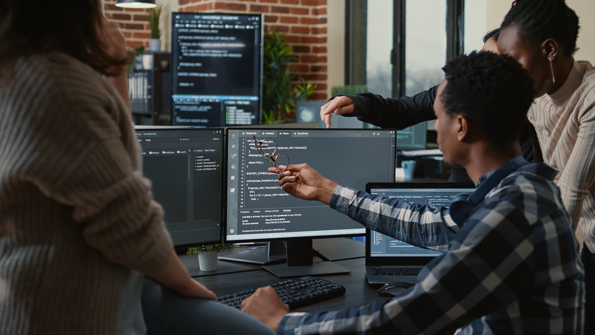 Software developers are pictured looking over a program.