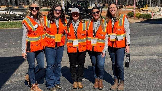 Caterpillar team members pose for a group photo as part of the Women in Construction group