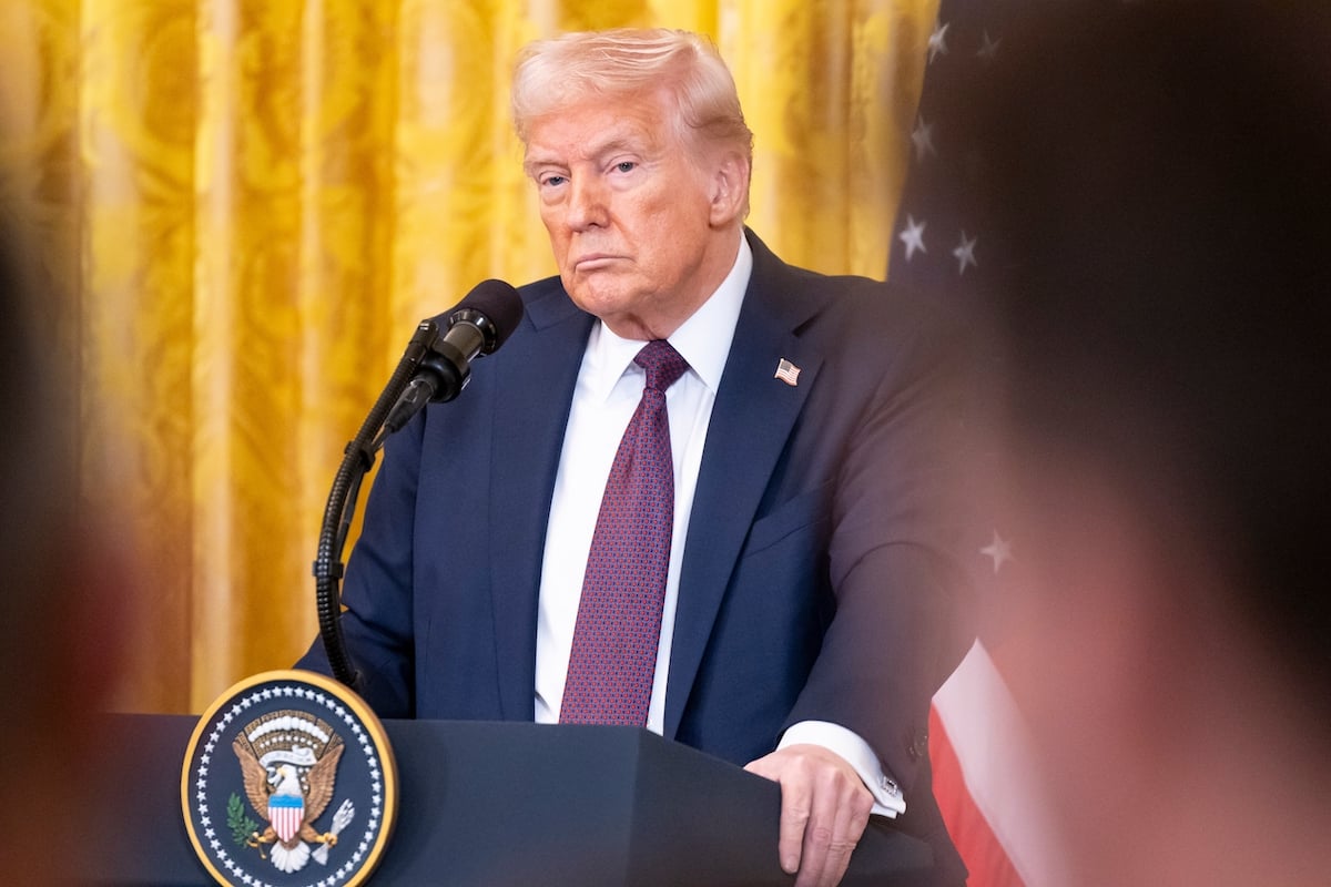 President Donald Trump stands at a lectern.
