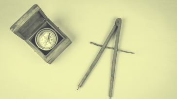 A yellow-toned image of a magnetic compass and a cartographical compass. meditation-studio-app-pivot 