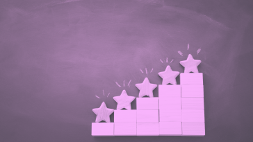 A purple-toned image of building blocks arranged in ascending steps, each topped with a star-shaped block 5-qualities-success-sales-engineering