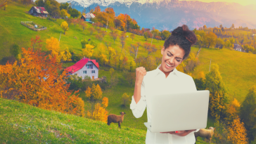 developer with laptop, hillside in the background