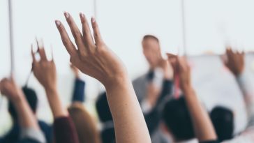 hands raised in an office best questions