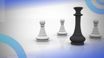 A black queen chess piece stands in front of three white pawn chess pieces. /career-development/when-how-develop-influence