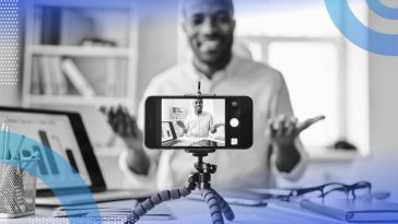 A cell phone on a tripod captures video of a man making a presentation. /marketing/influencers-go-corporate