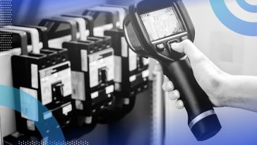 A technician points a thermal imaging camera at some equipment. /artificial-intelligence/ai-reduce-energy-waste-manufacturing