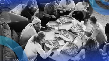 A group of people gather around a table covered with different pizzas. /remote-work/make-remote-work-more-fun