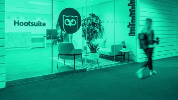 Hootsuite's office redesign with their logo on a glass wall.