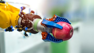robotic arm holding an apple