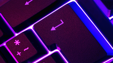 A close up image of a return key on a work keyboard.
