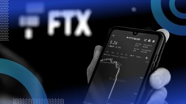 A person looks at a smartphone showing plunging stock prices in front of an FTX logo