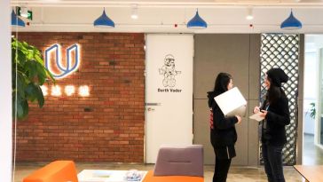 Two Udacity employees chat in the Shanghai office