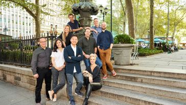 Giant Machines team members pose on the steps to a park in New York City