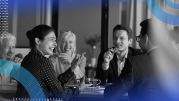Employee relations image of a group of employees interacting and laughing in a casual atmosphere — maybe a coffee, lunch or happy hour.