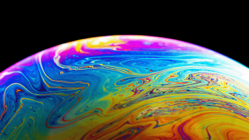 A close-up view of a bubble reflecting a rainbow of colors.