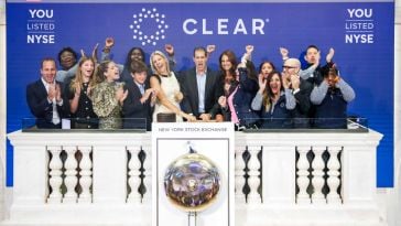 Members of the CLEAR team ring the bell at the New York Stock Exchange