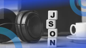 JSON image of a pair of headphones and a cup of coffee on a desk. In between them we see a pair of blocks stacked vertically spelling out J S O N