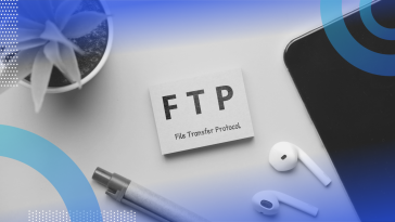 file transfer protocol (FTP) image of a post-it note pad with FTP file transfer protocol written on it. The note pad sits on a desk. A plant, a pair of airpods and a pen are also visible on the desk.