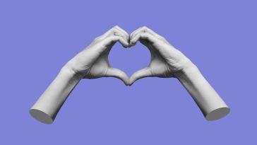 Two hands make a heart symbol in front of a purple background.