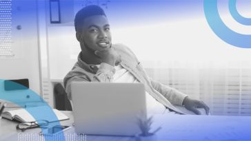 a Black businessperson at a computer. Hiring Black-owned vendors and visiting Black-owned businesses can help build wealth in the Black community.