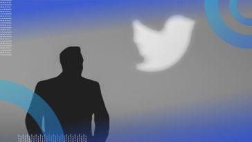 A silhouette of Elon Musk in front of the Twitter logo