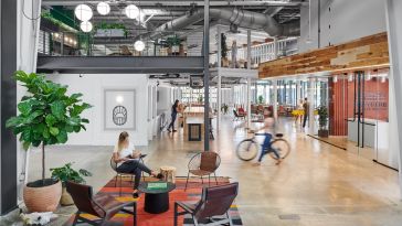 Photo of the interior of Favor's Eastside tech hub office space, with people moving about.
