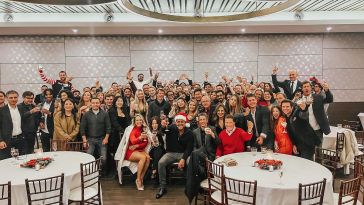 NAX Group team members posing for photo at company holiday party 