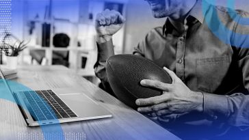 A person with a football and computer. AI can crunch stats and make predictions that can make fantasy football even more fun. 
