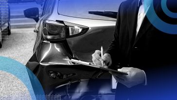 A man signing a paper on a clipboard in front of a rear-ended car.