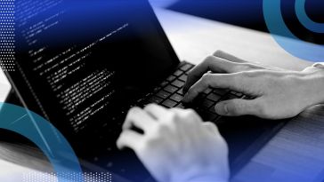 Developer writing python code on a laptop