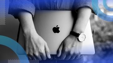A woman wearing a watch holds a Macbook