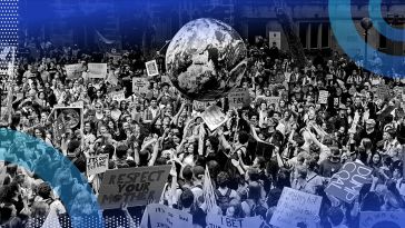An environmental rally with a huge globe in the middle
