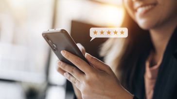  A customer selects a five-star rating on their cell phone.