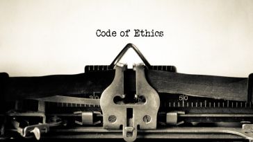 A typewriter with the phrase code of ethics