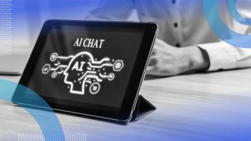 A close-up of a propped-up iPad with “AI CHAT” on the screen and a business person sitting across from it.