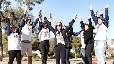 Ellevation Education team members jumping with hands raised in air