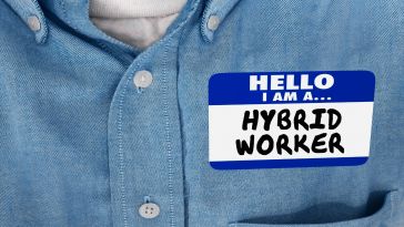 a person wearing a name-tag that says 'hybrid worker' on it.