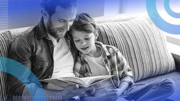 A man reading to a happy-looking child.