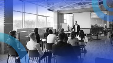 Employees at a learning and development session in a windowed conference room.