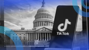 TikTok on a phone with the Capitol Building in the background.