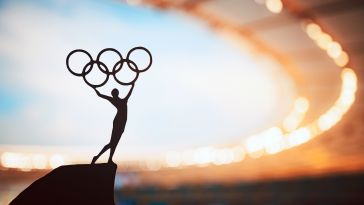 The silhouette of an Olympic statue is pictured.