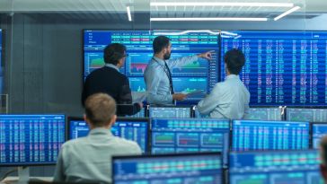 Employees at a trading firm analyze stock market data.