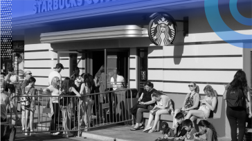 Customers are lined up outside of a Starbucks store.