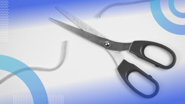 A pair of scissors cutting a string